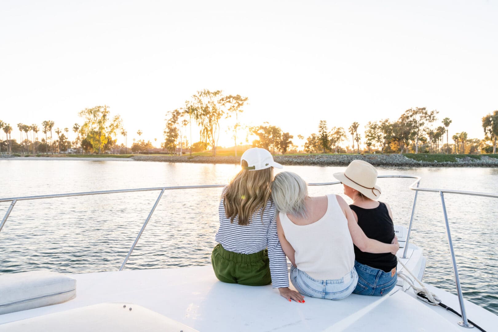 The Back of Three Women Sitting on a Boat