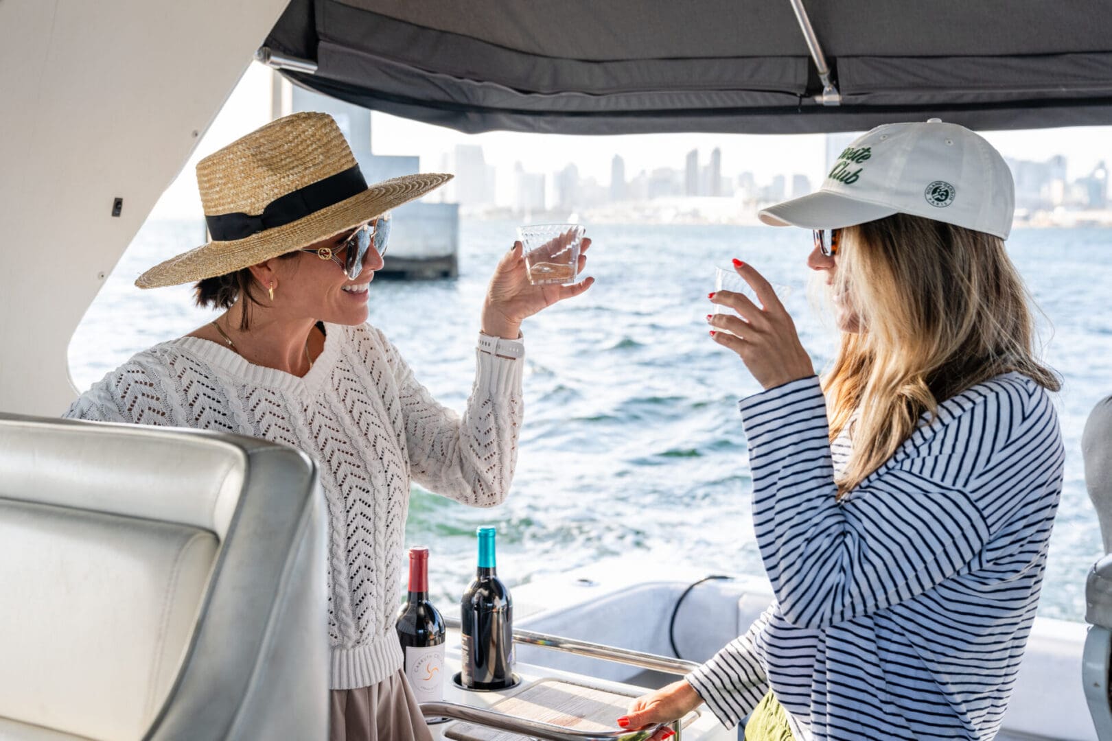 Two Women on a Boat Holding Glasses