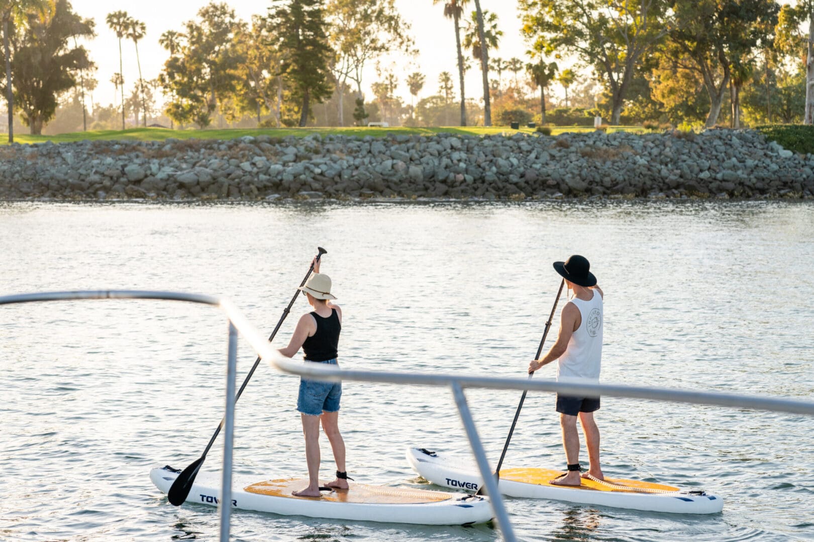 Two Men Standing on Rowing Boards